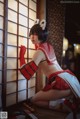 A woman in a red and white outfit is posing for a picture.