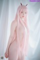 A naked woman with long pink hair and horns.